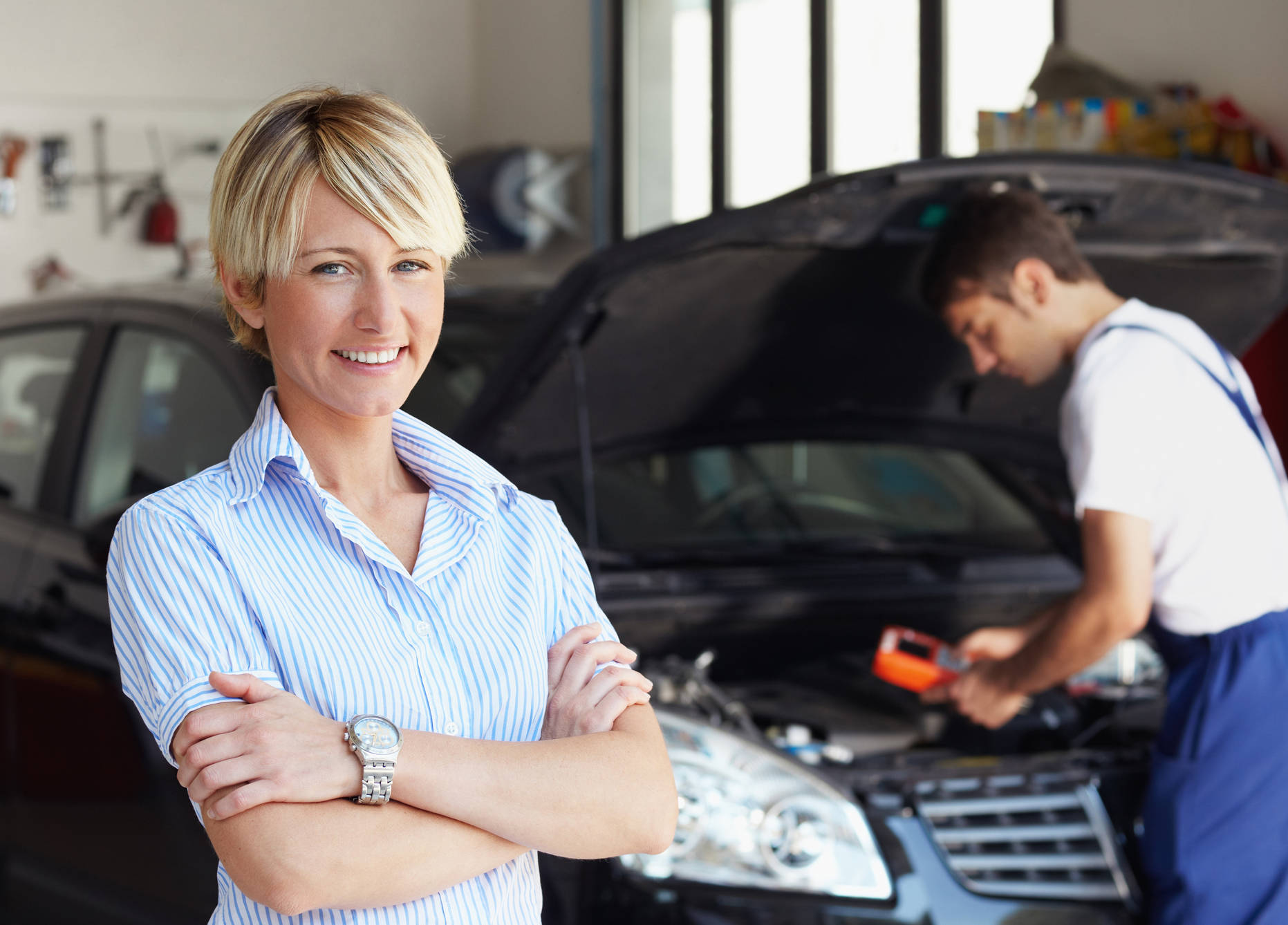 motor mechanics servicing a car